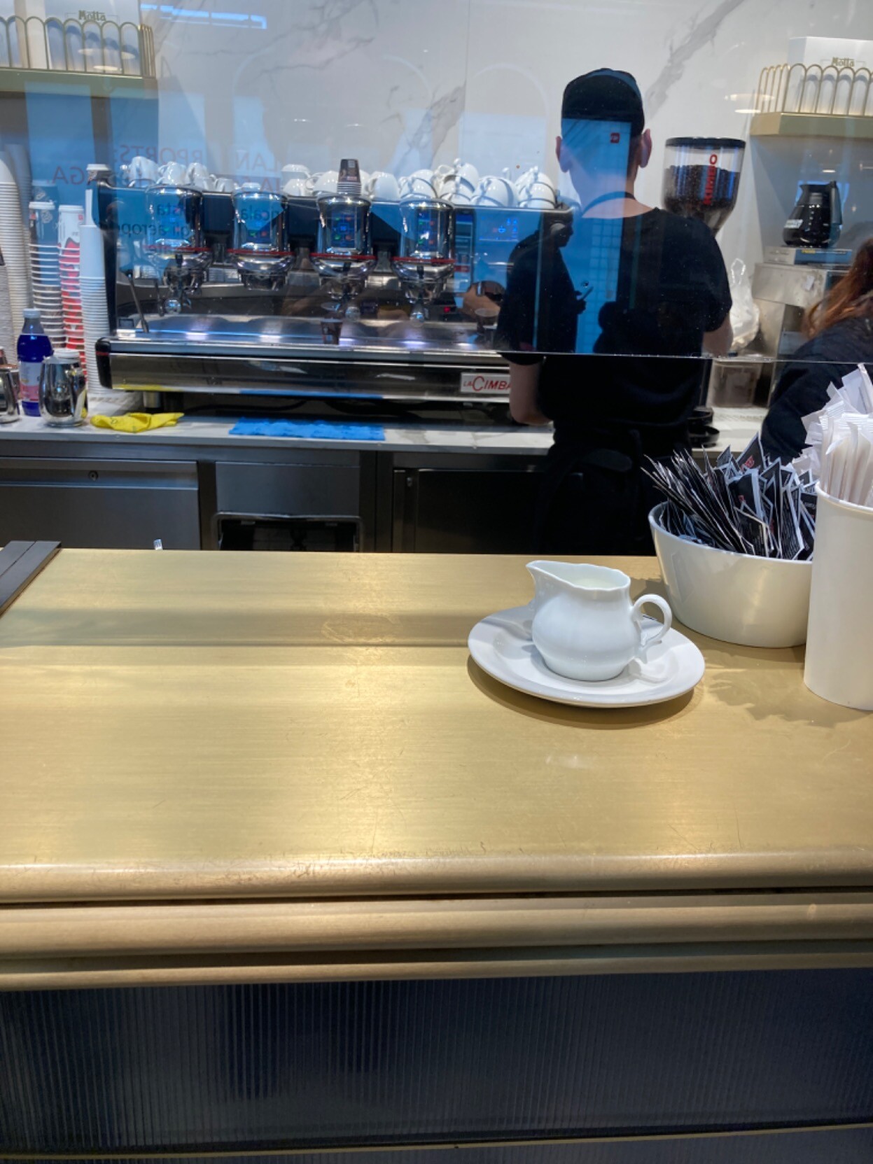 Counter with hulking espresso machine in background