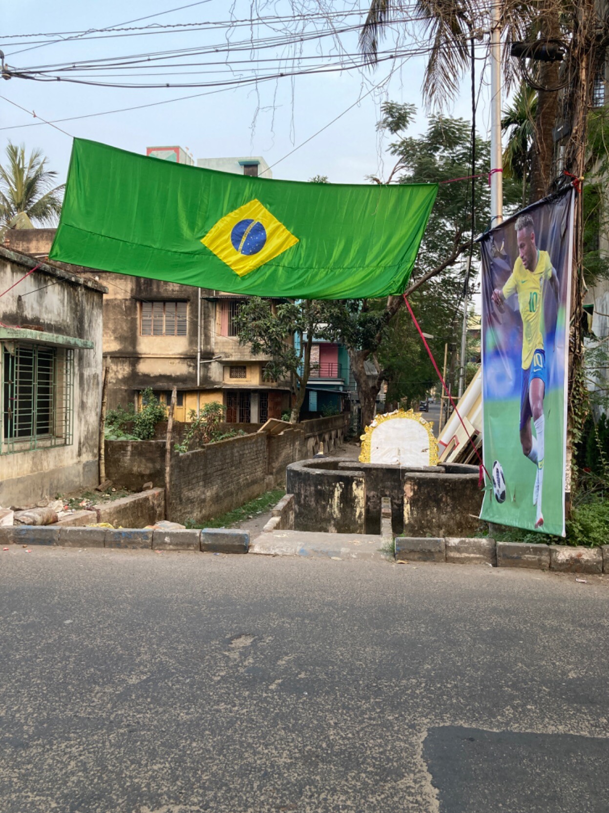 Giant Brazilian flag hung over the entrance to an alley with an equally large picture of Neymar hanging to the right