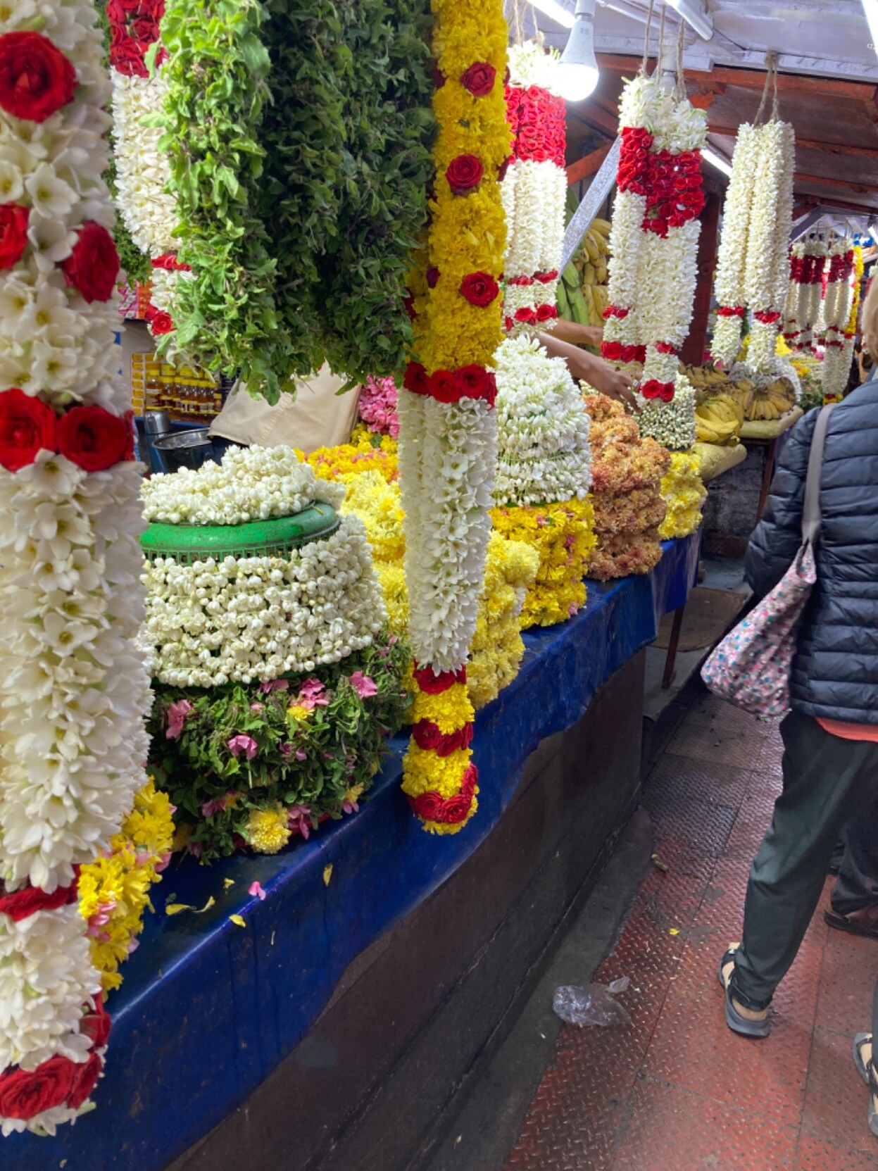 Multicolored ropy garlands and other floral arrangements on offer