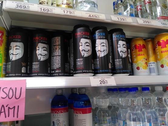 Cans with the label hacker and the anon mask on a shelf in a supermarket