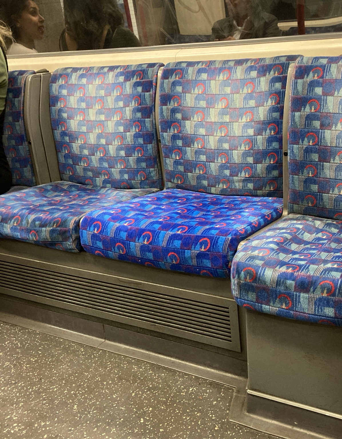 3 plush seats from across the aisle in a Tube coach