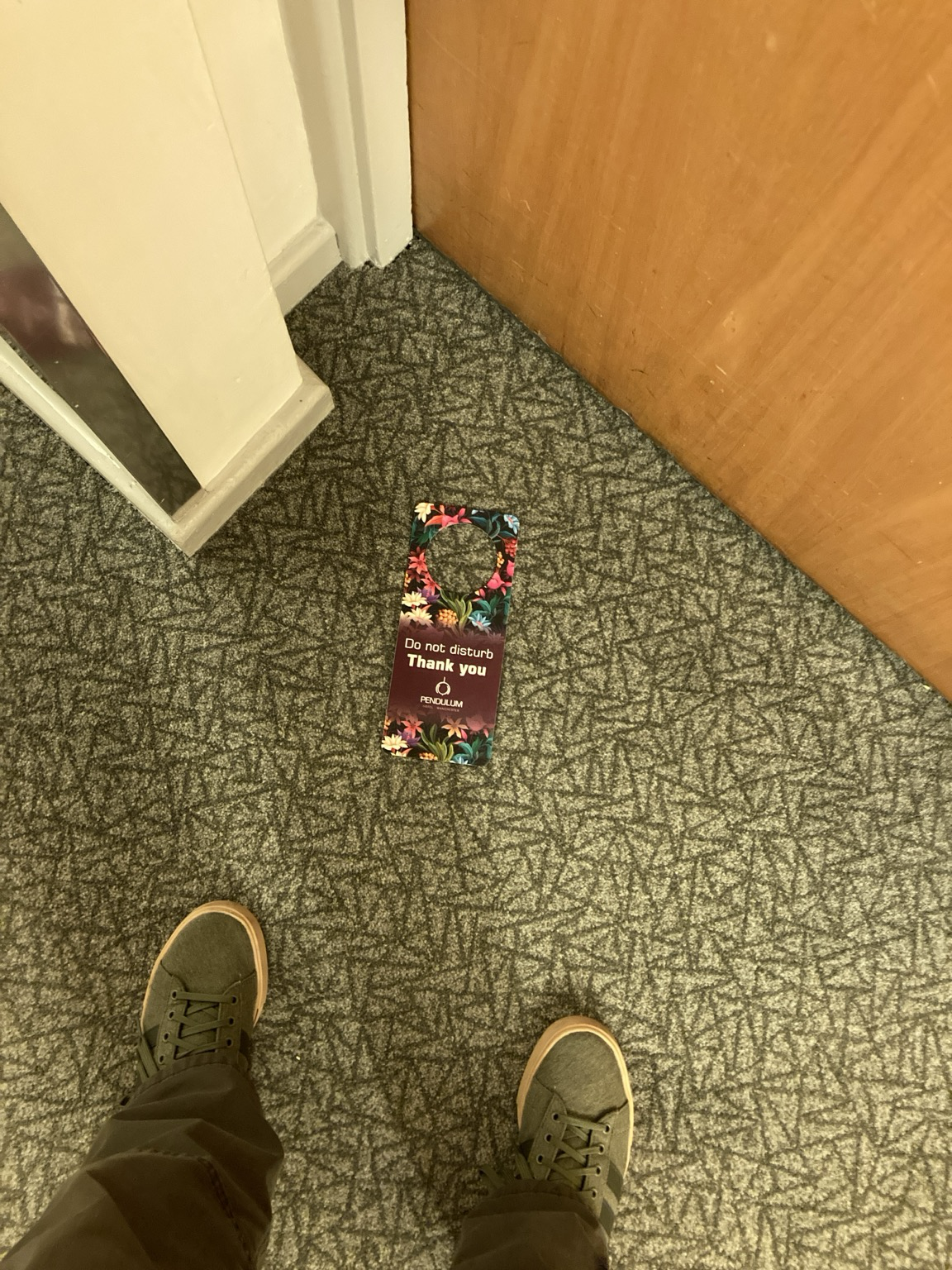DO NOT DISTURB tag on the carpet in front of a hotel door