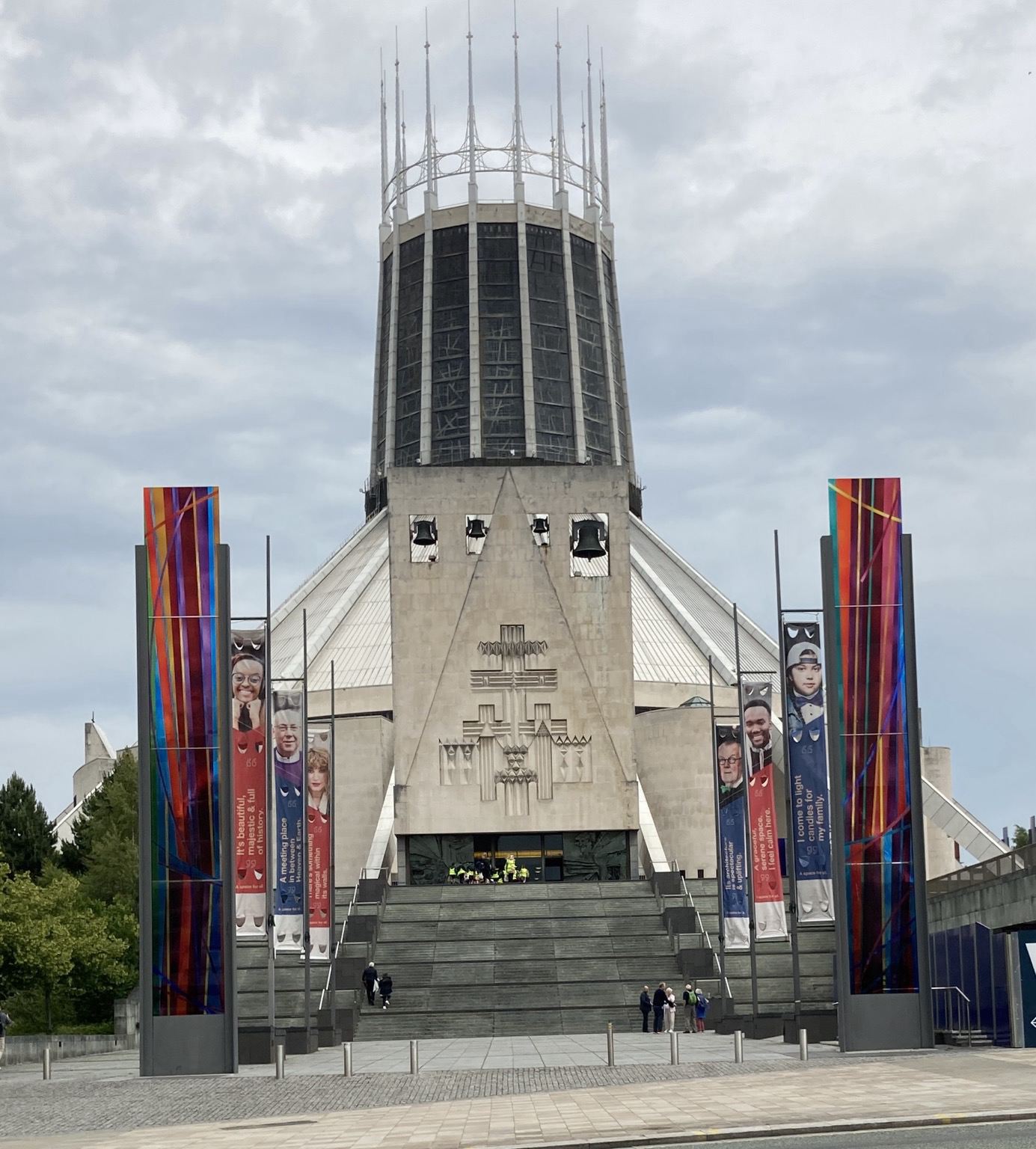 From across the street up a few flights of stairs, a huge white cylindrical stone building with flying buttressesand a sort of crown surmounted by many high metal spikes