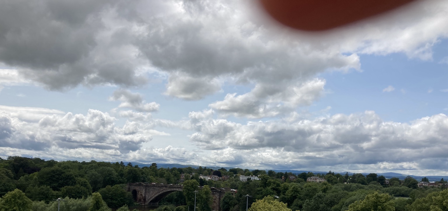 Distant hills under a mostly cloudy sky