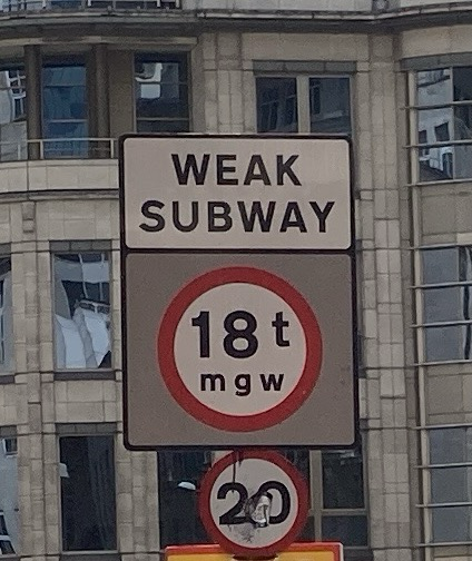 Sign on street: WEAK SUBWAY 18t mgw