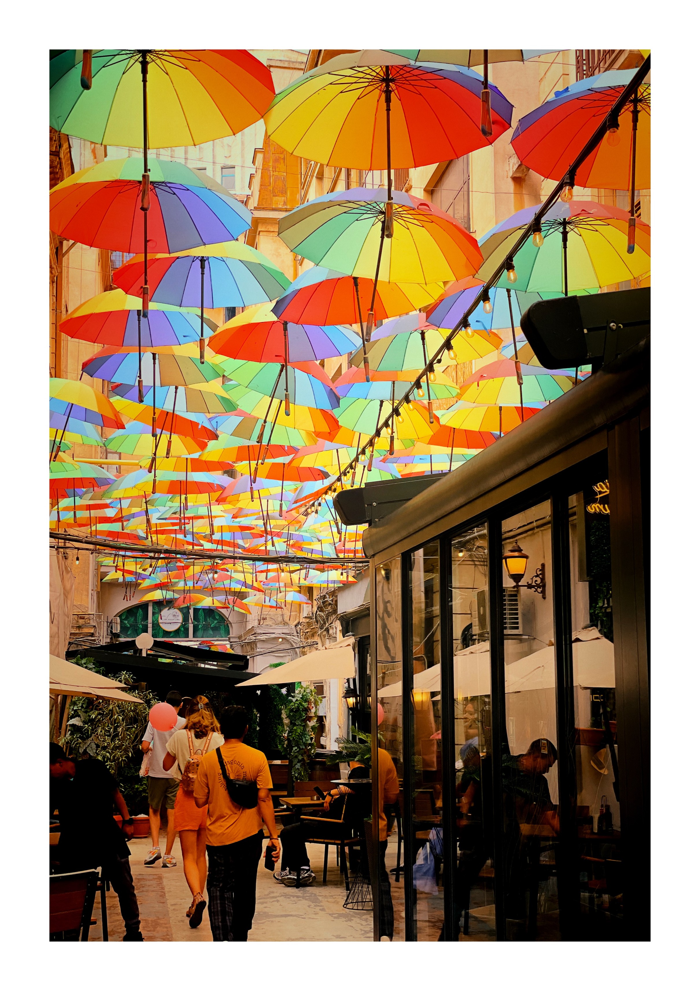 Bunte Regenschirme hängen über einer schmalen Gasse in Bukarest Bunte Regenschirme hängen über einer schmalen Gasse in Bukarest