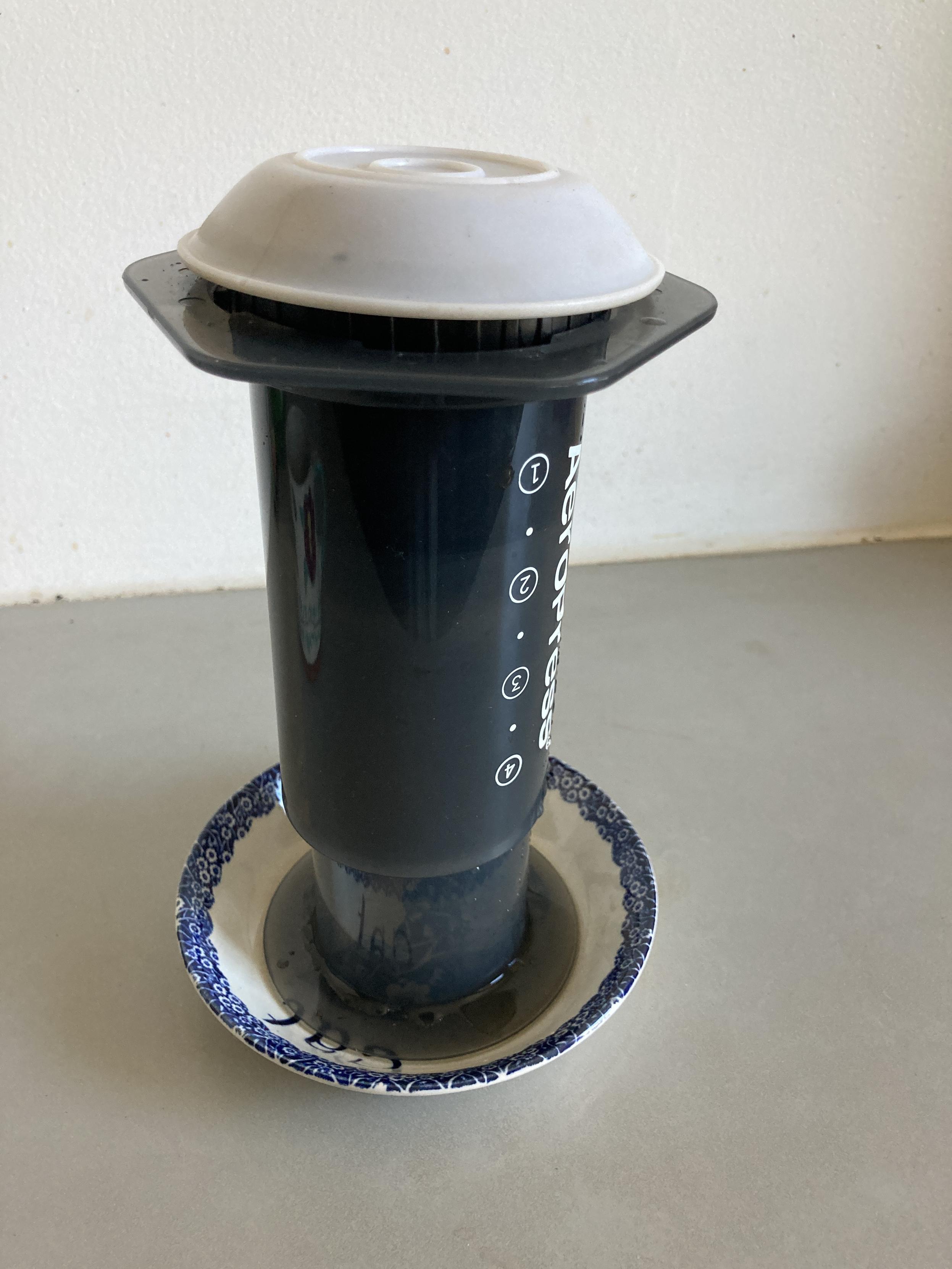 Aeropress brewing tea in inverted position with an inverted plastic bowl on top to retard heat loss.
