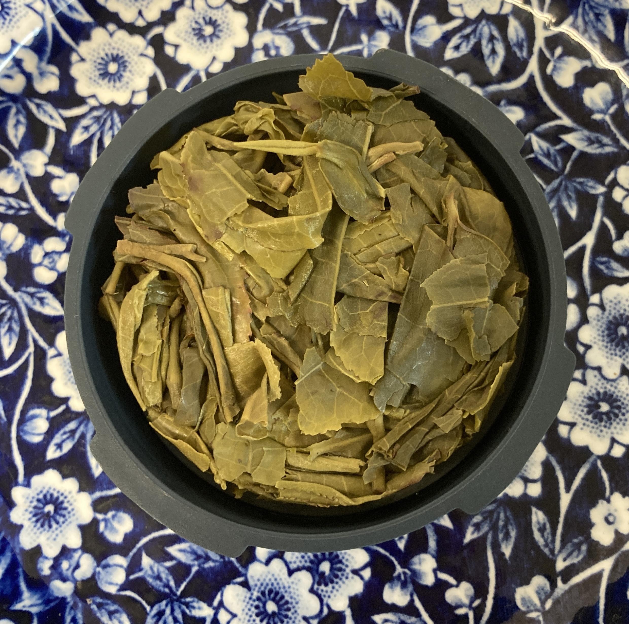 Puck of squeezed green tea leaves encased in a Prismo filter cap