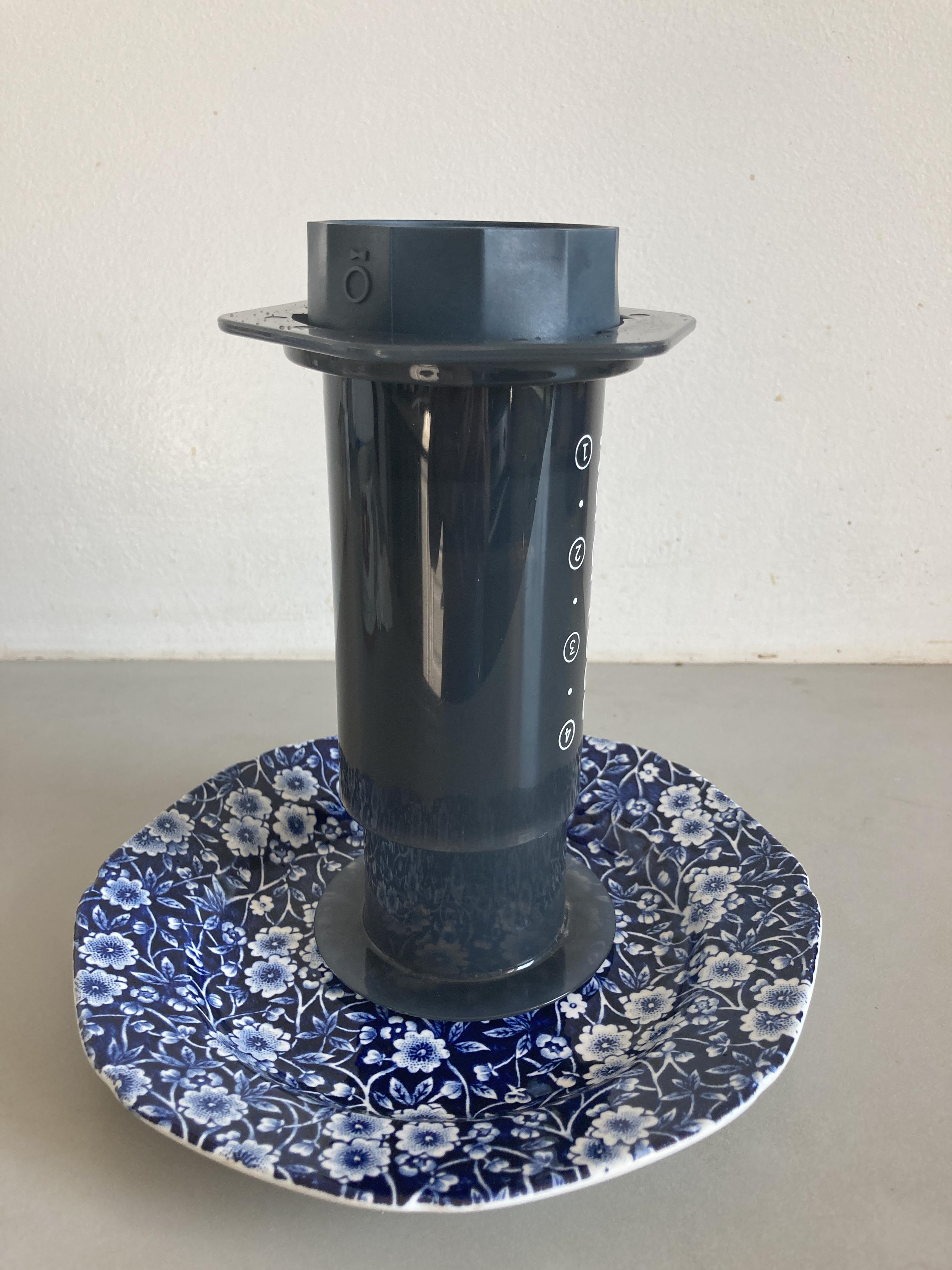 Inverted Aeropress with Prismo screwed on with ~70 ml of tea being brewed (the level of the plunger is hard to see behind the translucent plastic chamber wall.)
