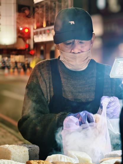 A street for vendor preparing a snack for me, with packaging in front 