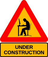 Ein „under construction“ Verkehrszeichen (rot umrandetes Dreieck), das auf gelbem Grund als schwarzen Scherenschnitt einen am Computer arbeitenden Menschen zeigt