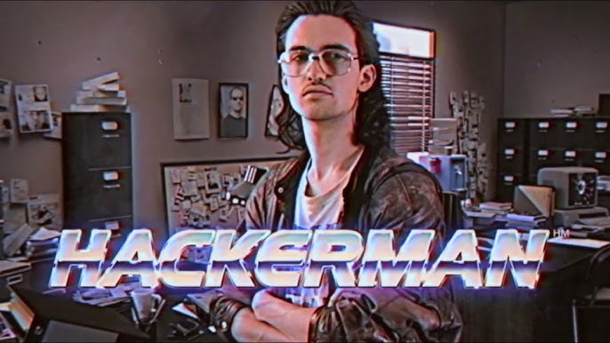 still frame from Kung Fury in VHS quality style where a young man with longish hairs and glasses looks into the camera. Chrome letters are superimposed HACKERMAN