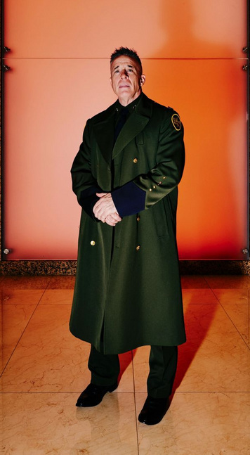 ICE officer Gregory Bovino wearing a long, dark-greenish coat.