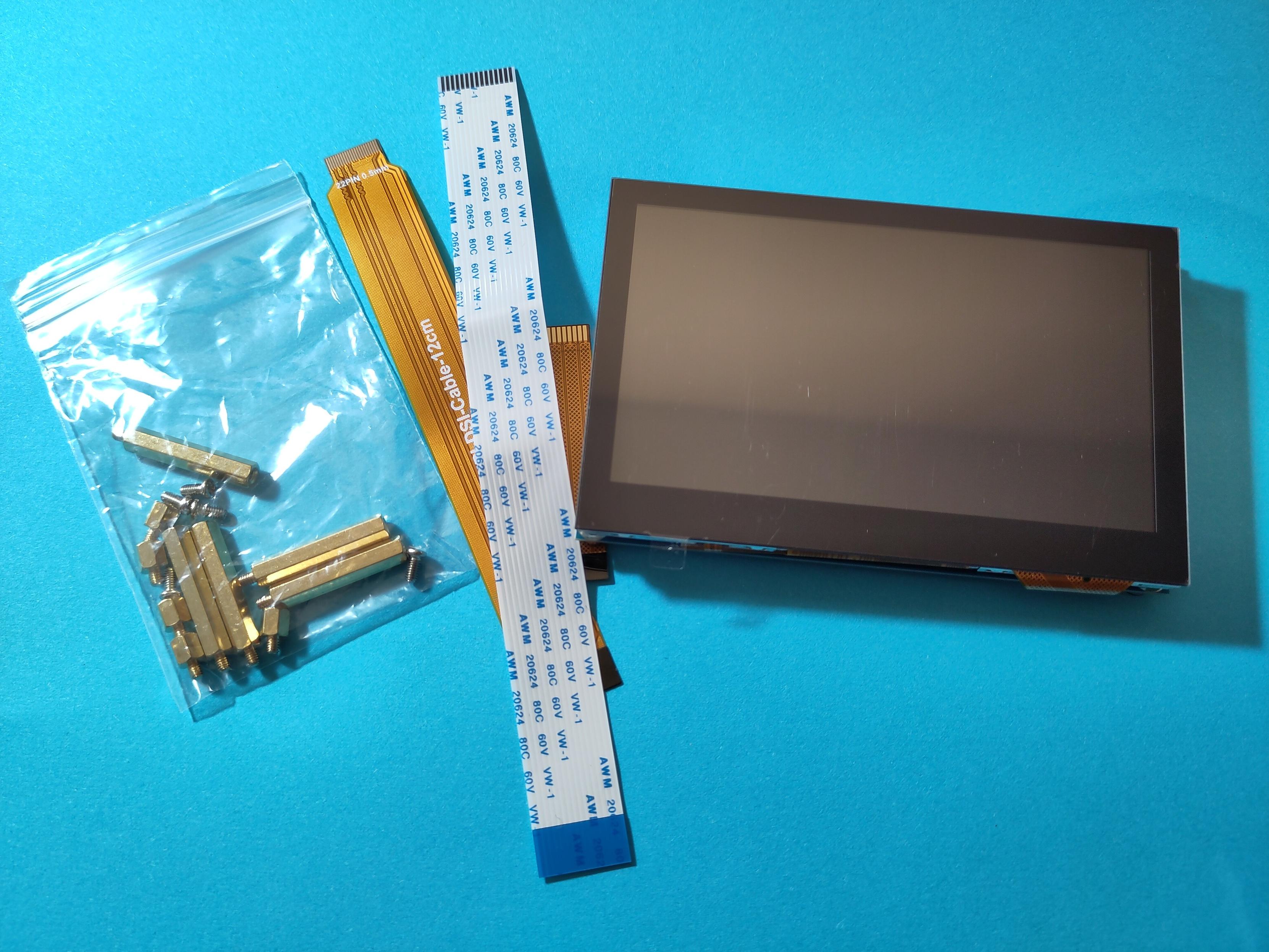 A Waveshare 4.3 inch DSI LCD touchscreen display next to accessories. The screen will be installed in my Voron Trident and will be run with KlipperScreen.