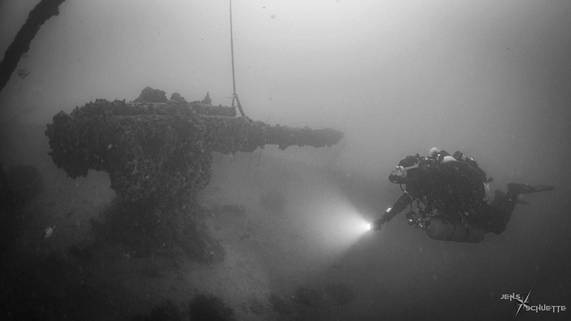 Scuba diver at the canon of the Ceasare Rossarol.