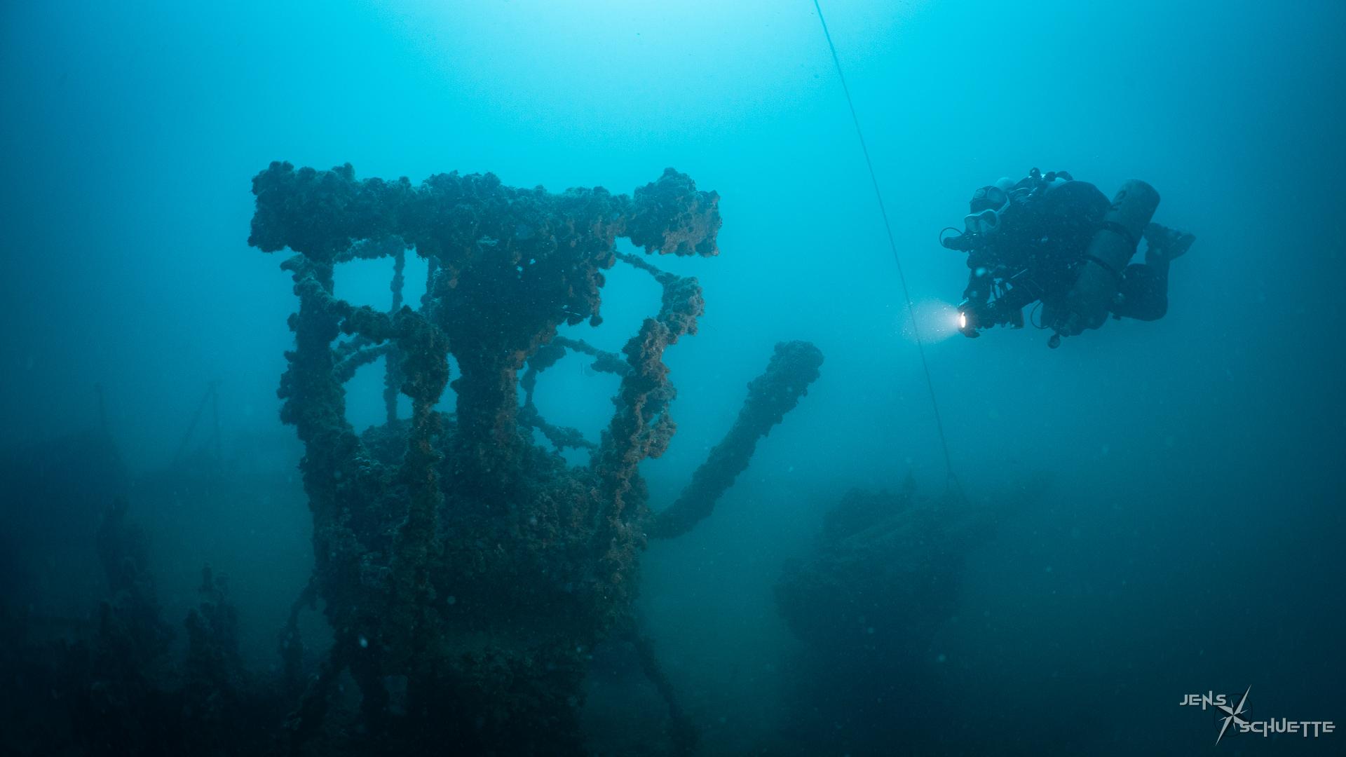 Scuba diver at the range finder of the Ceasare Rossarol.