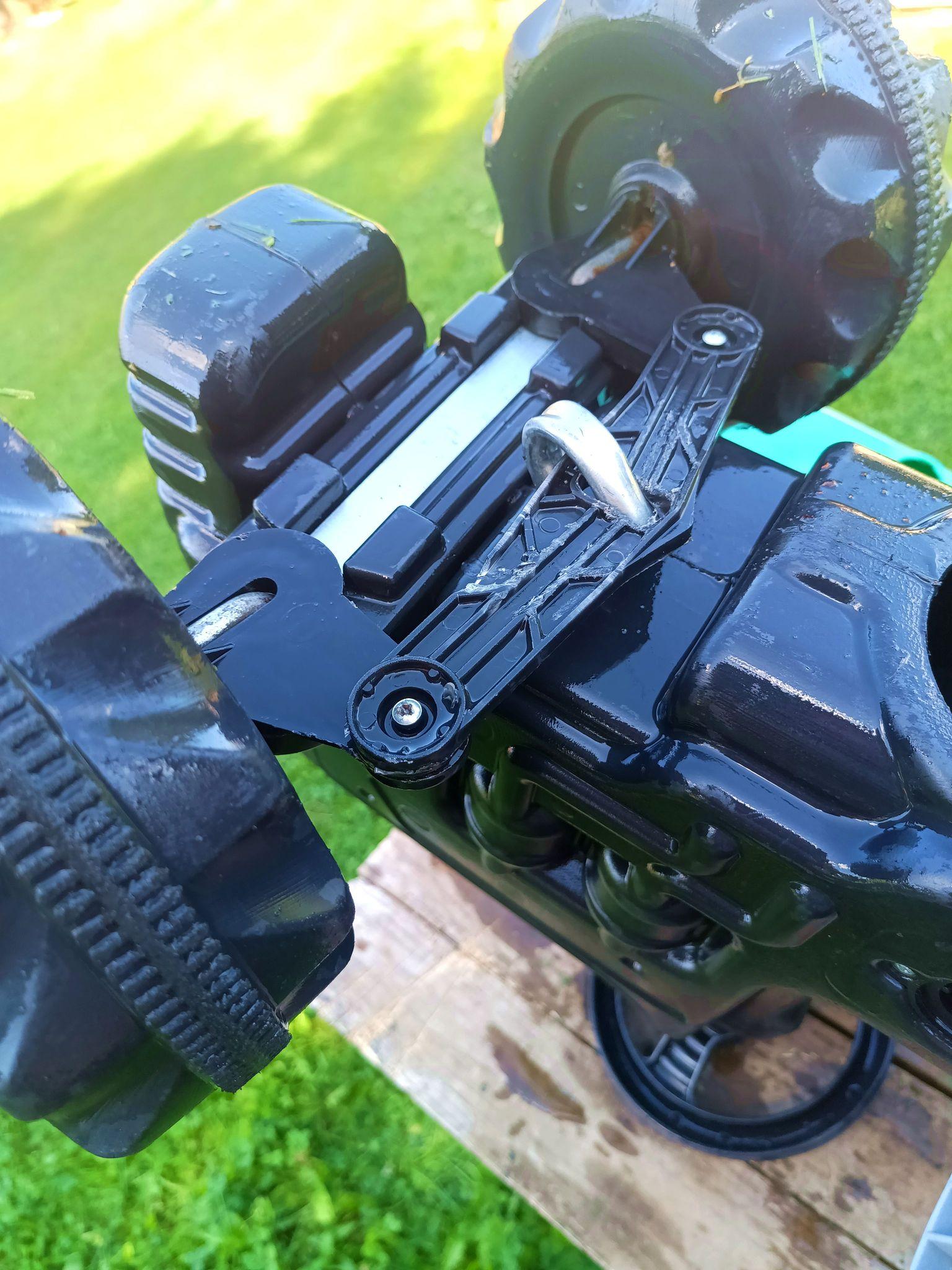 The steering linkage. A metal walking stick from the steering wheel hooks into it. The rest is plastic.
