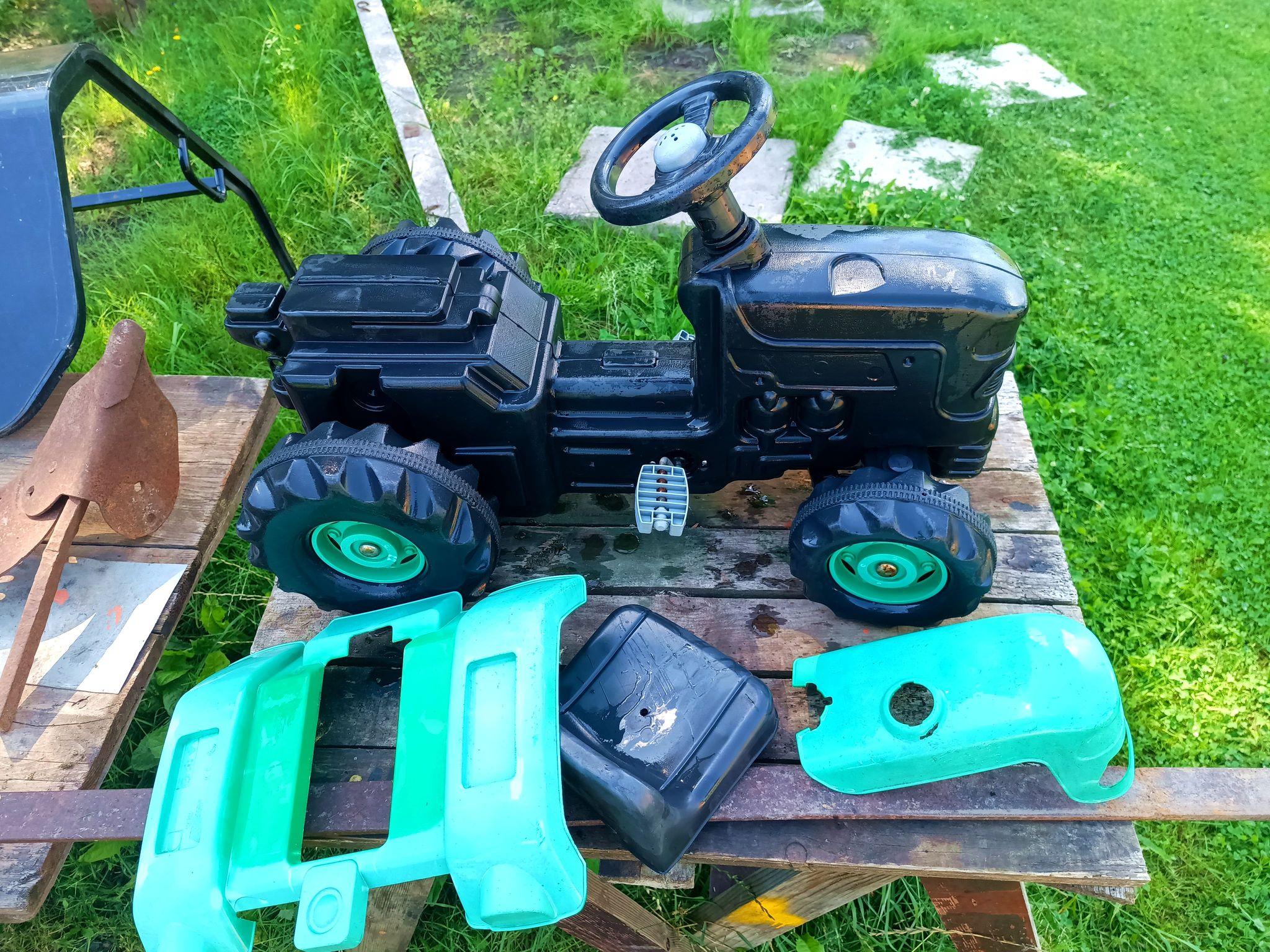 Ride-on plastic tractor, shells and seat removed to get all the sand out.